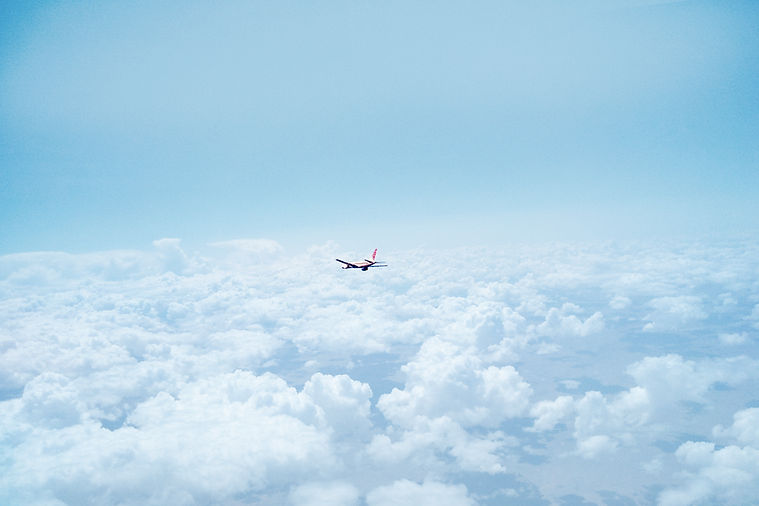 Airplane Above the Clouds