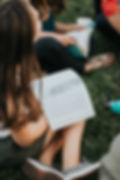 a group of people sitting on the grass reading a book_edited.jpg