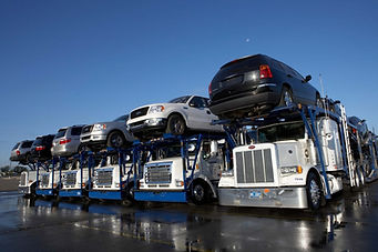 semi truck with cars lined up