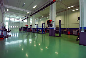 An-empty-repairs-garage-with-green-floor-460638261_1254x839 (2).jpeg