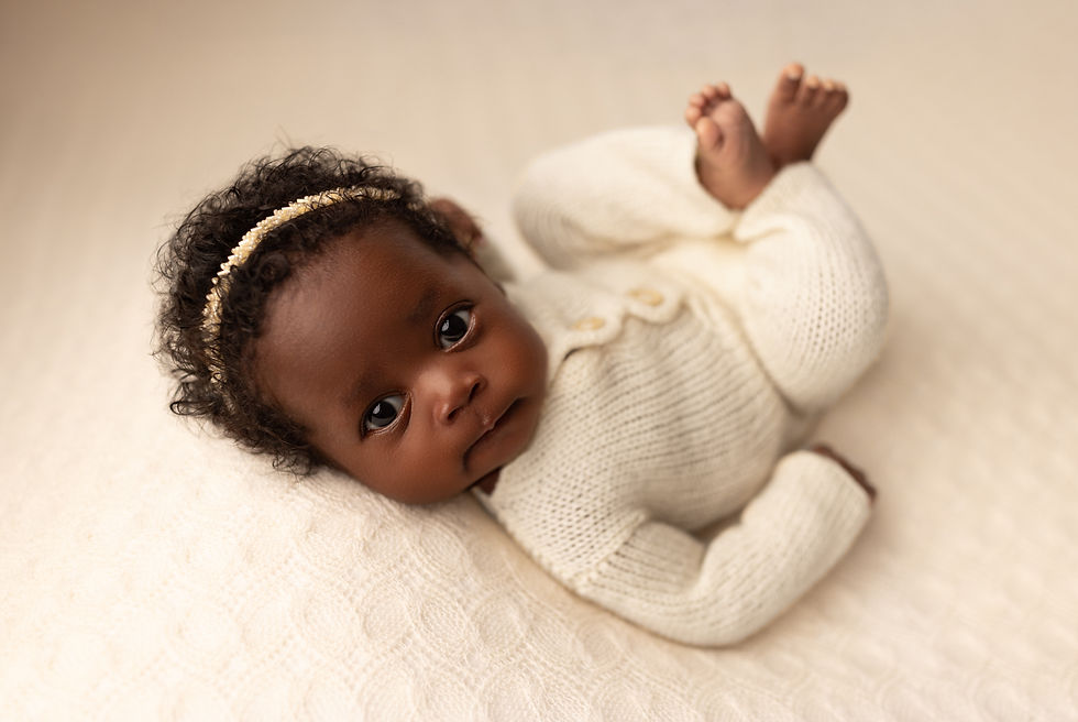 Baby girl looking at the camera during her Minnesota newborn photoshoot with Jordanalisa Photography