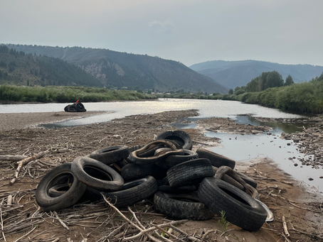 A pile of tires sits near the Eagle River in Edwards, CO.
