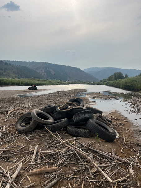 A pile of tires sits near the Eagle River in Edwards, CO.