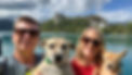 A couple in their 50s standing in front of Lake Bled with two dogs