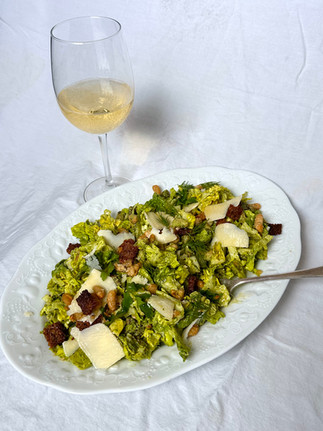 green goddess caesar salad and a glass of white wine
