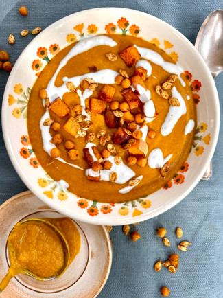 Bowl of carrot and parsnip soup with a full ladle