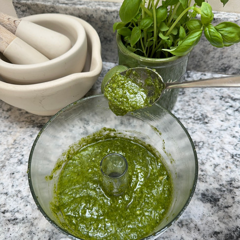 Basil pesto running off the spoon