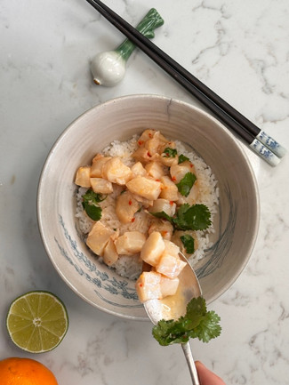Spooning the ponzu marinated cod onto the rice