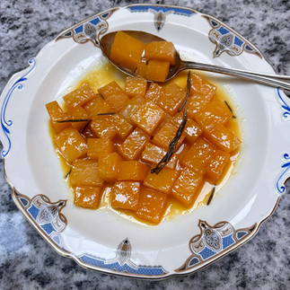orange and rosemary glazed swede on a spoon