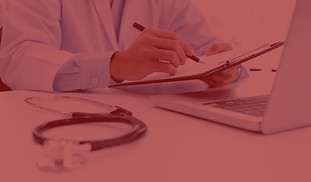 doctor-working-with-laptop-computer-writ