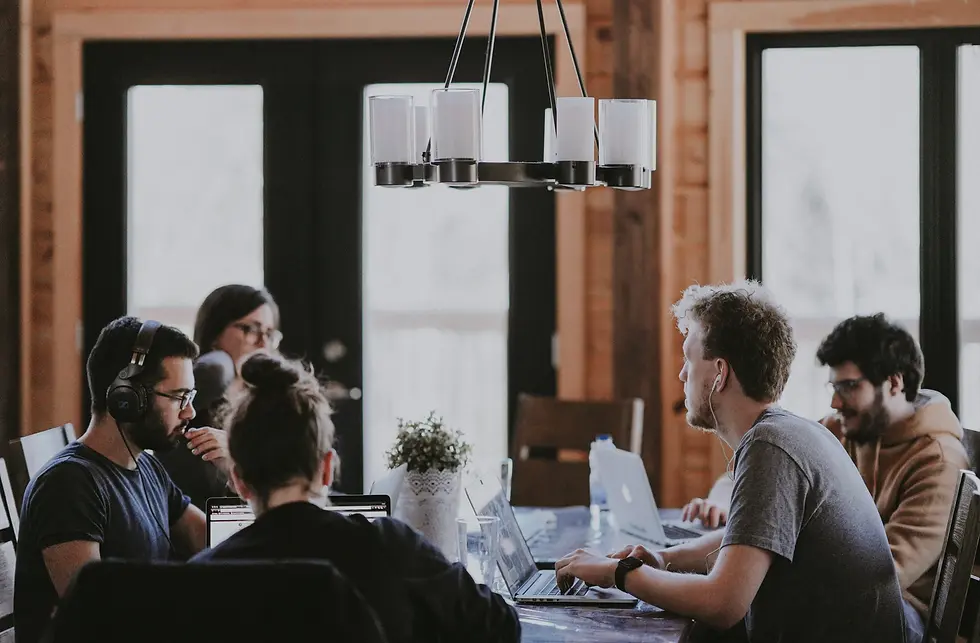 Teach team sitting in an open office table.