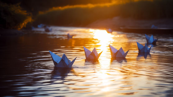 group-paper-boats-floating-top-lake-sunset-generative-ai.jpg