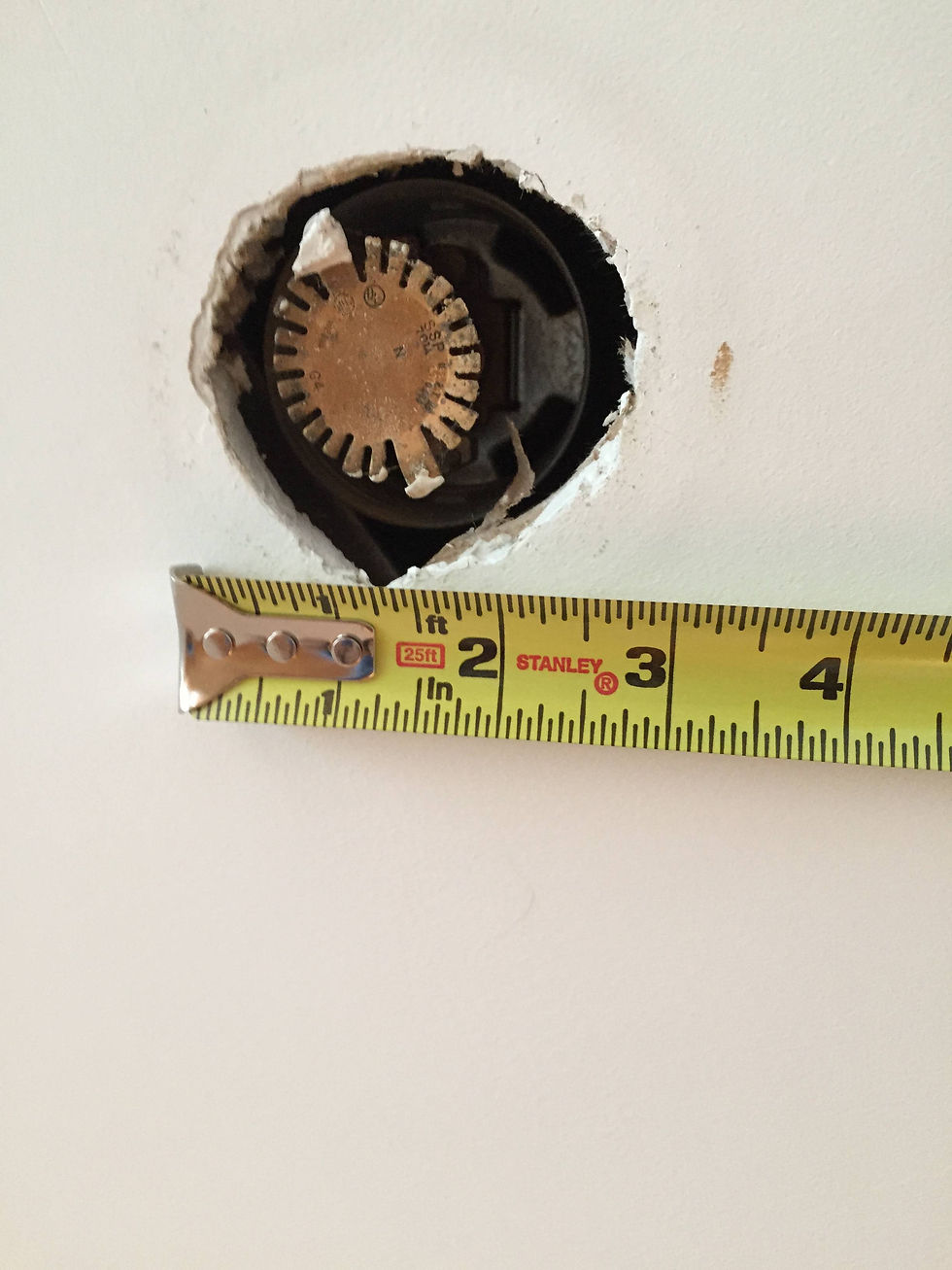 Fire sprinkler head installed with excessive ceiling clearance measured during a sprinkler system inspection