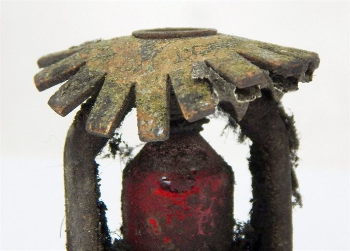 Corroded fire sprinkler head showing rust and damage that can prevent proper sprinkler system operation