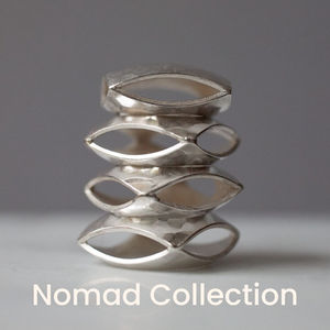 A stack of handcrafted Nomad pillow beads resembling abstract art.