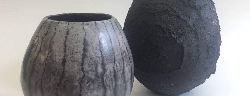 Two dark grey pots by Hannah Wilson