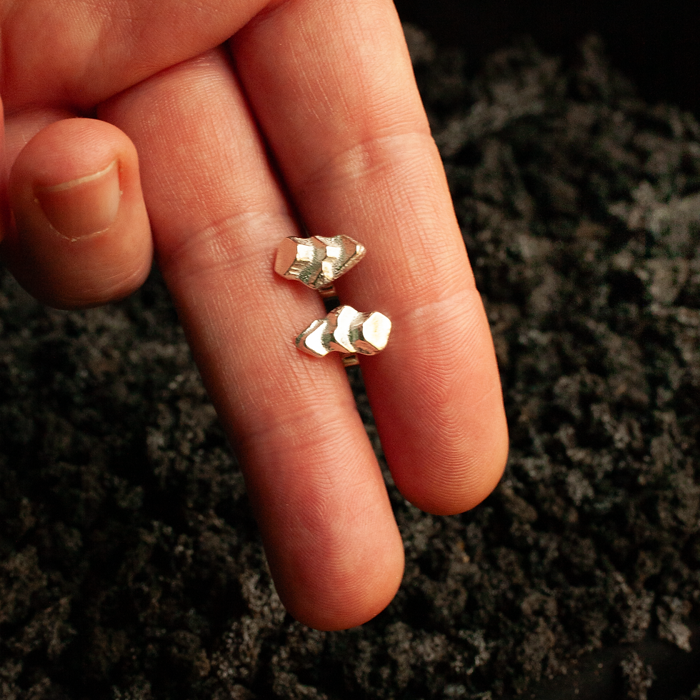 Thumbnail: size of fingers demonstrating size of handcrafted silver studs