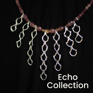 Gemstone necklace with seven elongate palmette silver arranged as a cascade at the centre.