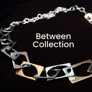Silver necklace featuring interlocking abstract silver pieces.