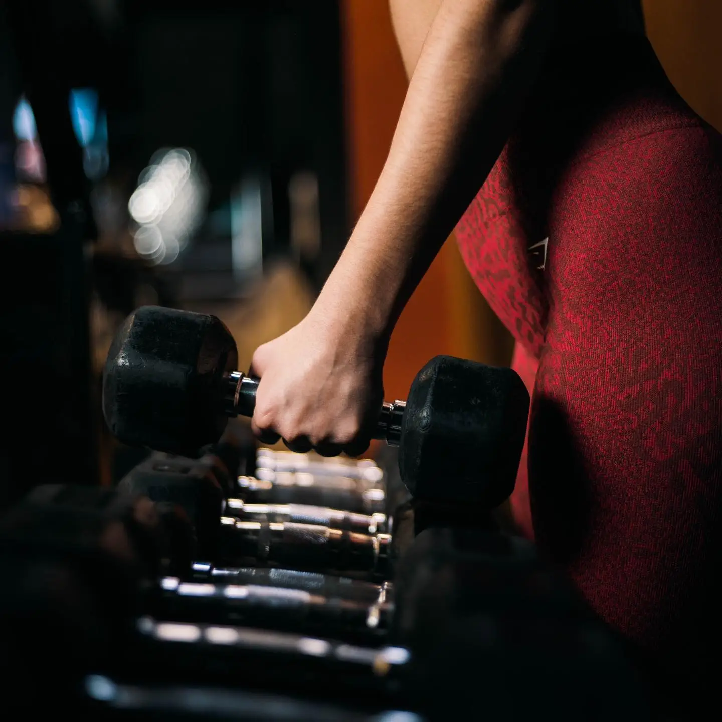 women-weight-training-with-dumb-bell.webp