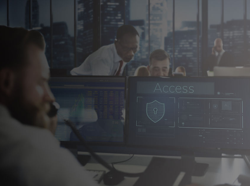 Two business people looking at a security monitor.