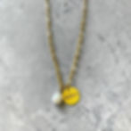gold neckace with engraved charm and fresh water pearl