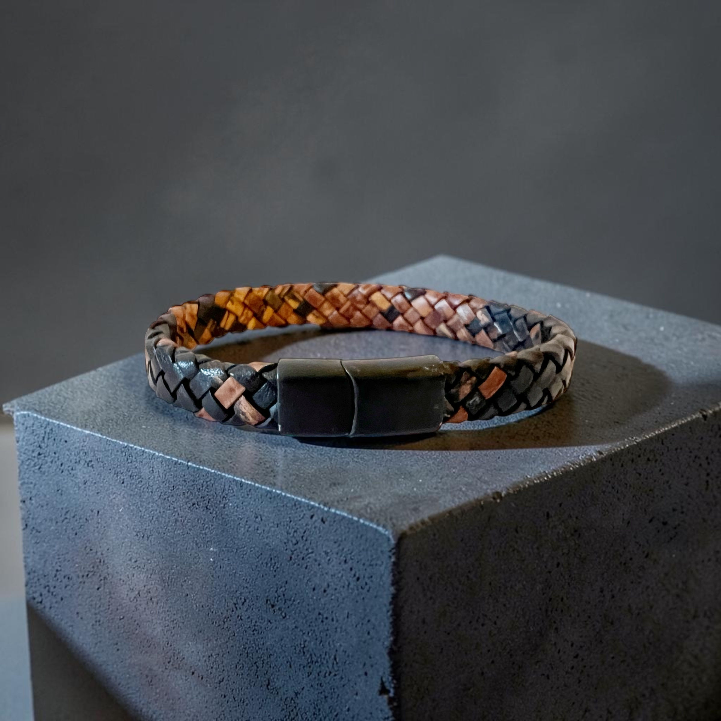 Men's sepia braided leather bracelet on podium