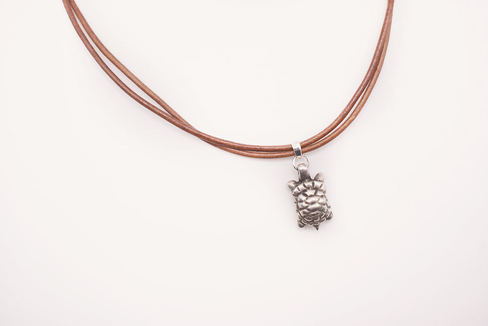 silver sea turtle on leather cord necklace overhead view