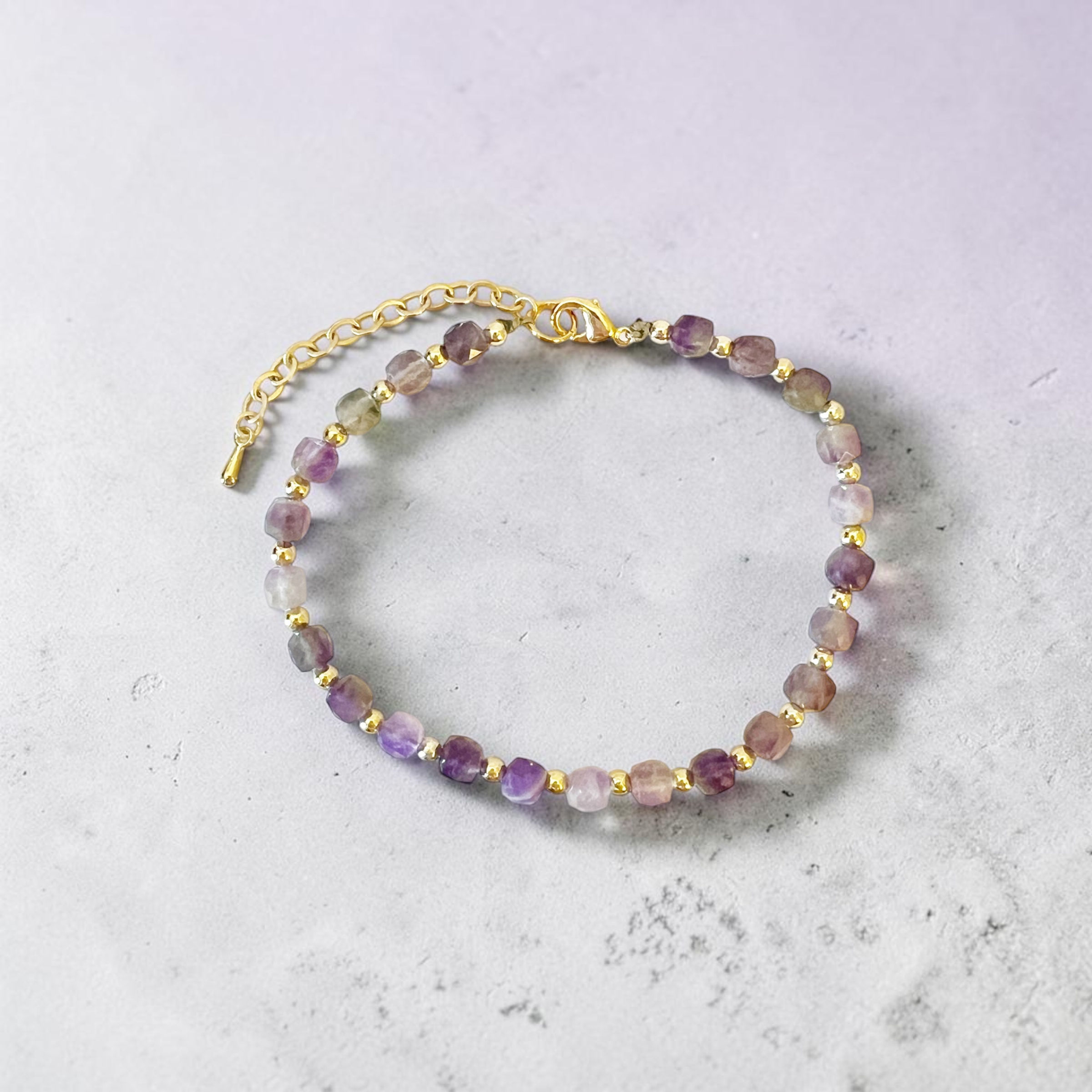 amethyst and gold beaded bracelet overhead view