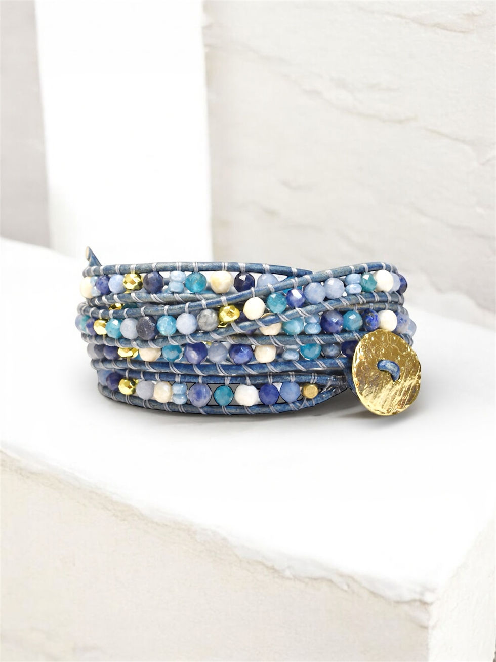 mix blue and gold leather wrap bracelet front view on counter