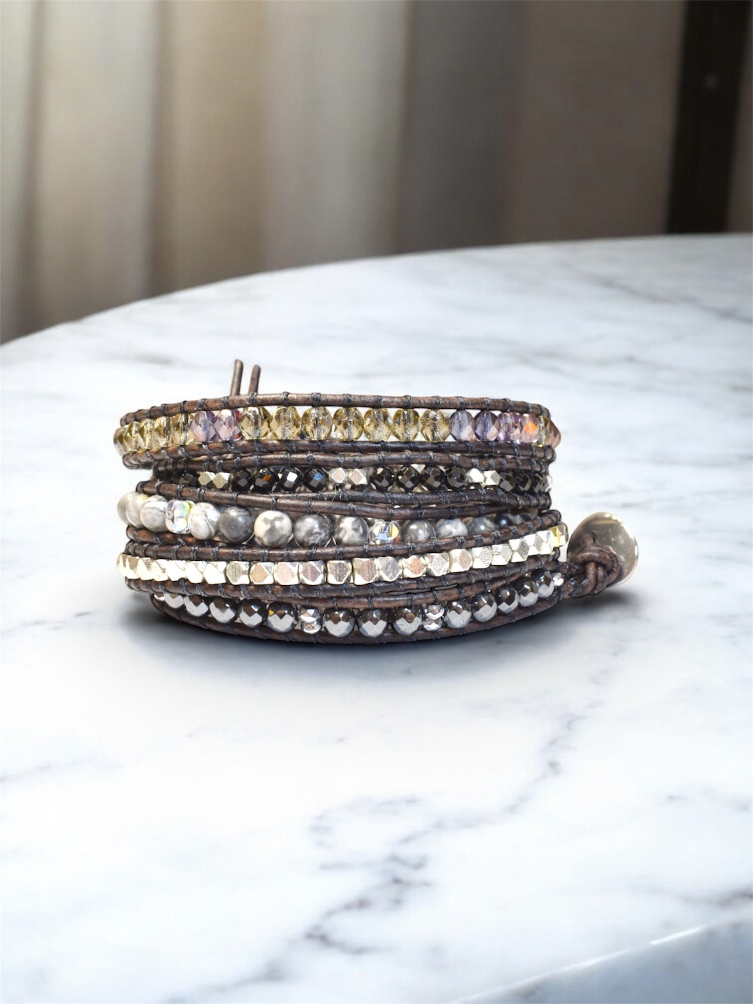 5 wrap beaded leather bracelet in gray, black and silver stones, on marble