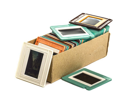 Collection of old 35mm photographic slides in their original plastic mounts and storage box.