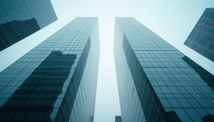 Eye-level view of a modern glass building with a subtle grid pattern overlay