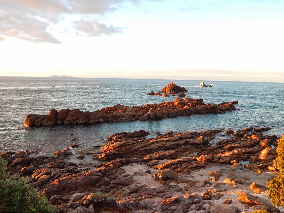 A barge in the distance, this rock reminds me of a sunken ship wreck