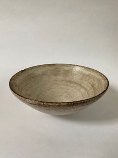 rough black clay bowl with satin cream glaze