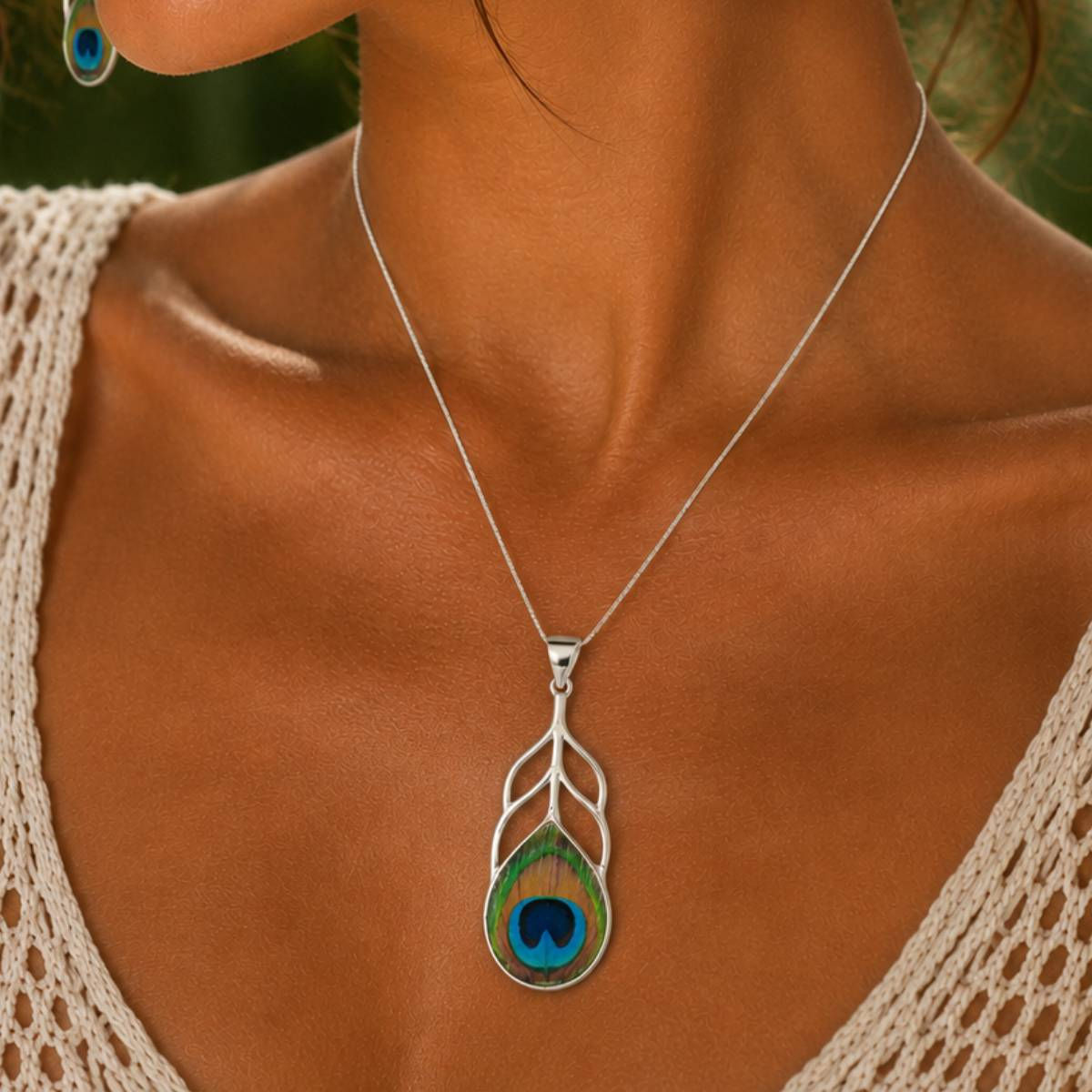 Woman wearing a peacock feather pendant.