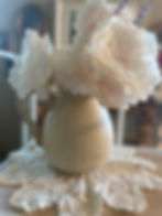 Back view of the "Lone Rooster" upcycled hand painted water pitcher shown with flowers