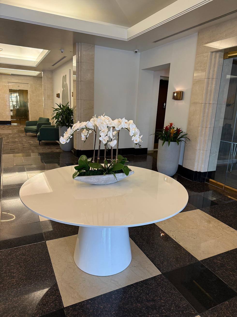 Hotel lobby with white table and orchids