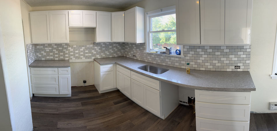 A modern kitchen sink with a sleek faucet, surrounded by a countertop