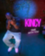 A musical artist, Kincy, performs "Time With You" on stage