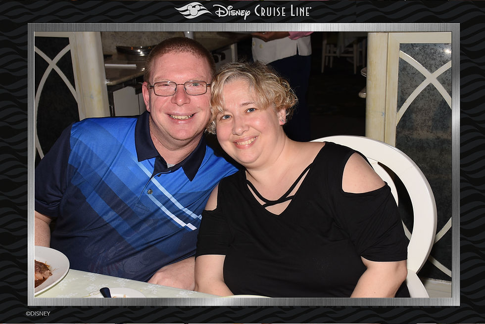 Man and woman smiling and posing together at a table.