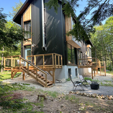 Cedar siding, black metal siding, metal grate deck
