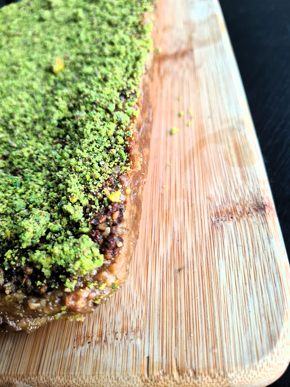 Pistachio baklava flapjack with scattered pistachio pieces on top.