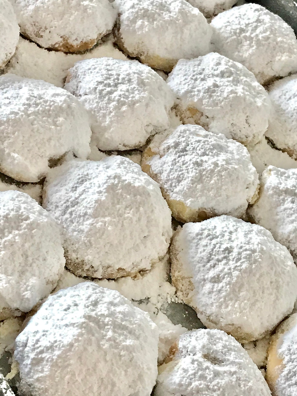 Traditional Greek kourabiedes, buttery almond cookies coated in a thick dusting of icing sugar
