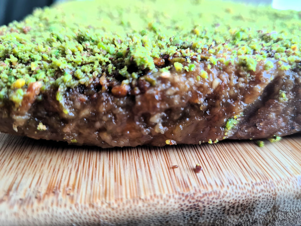 Pistachio baklava flapjack with glossy syrup layer.