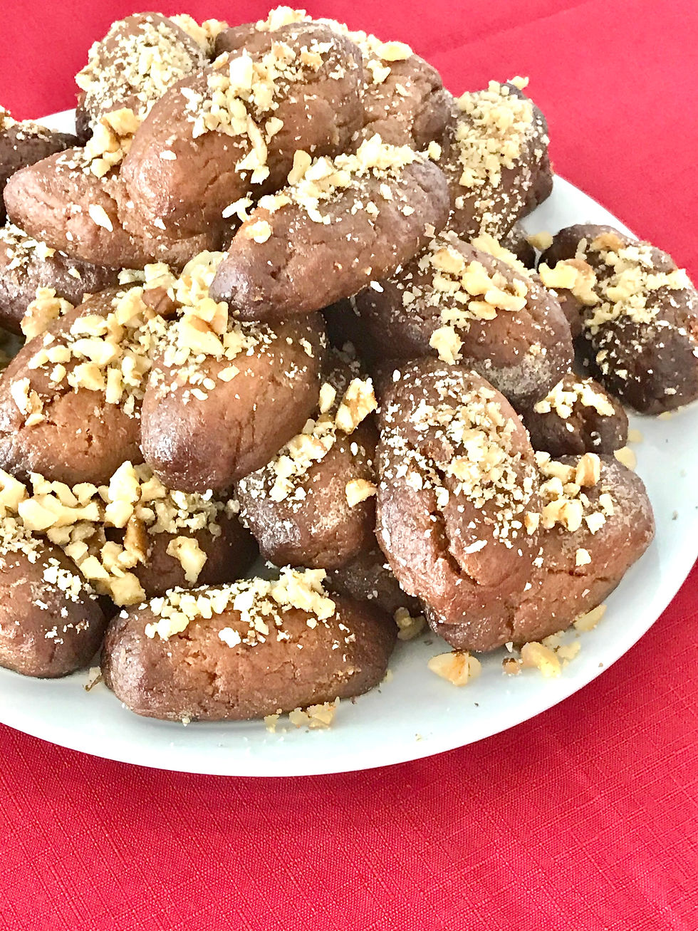 Greek melomakarona cookies dipped in honey syrup and topped with crushed walnuts