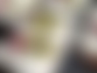 A mini Christmas fruitcake topped with white icing and festive marzipan decorations