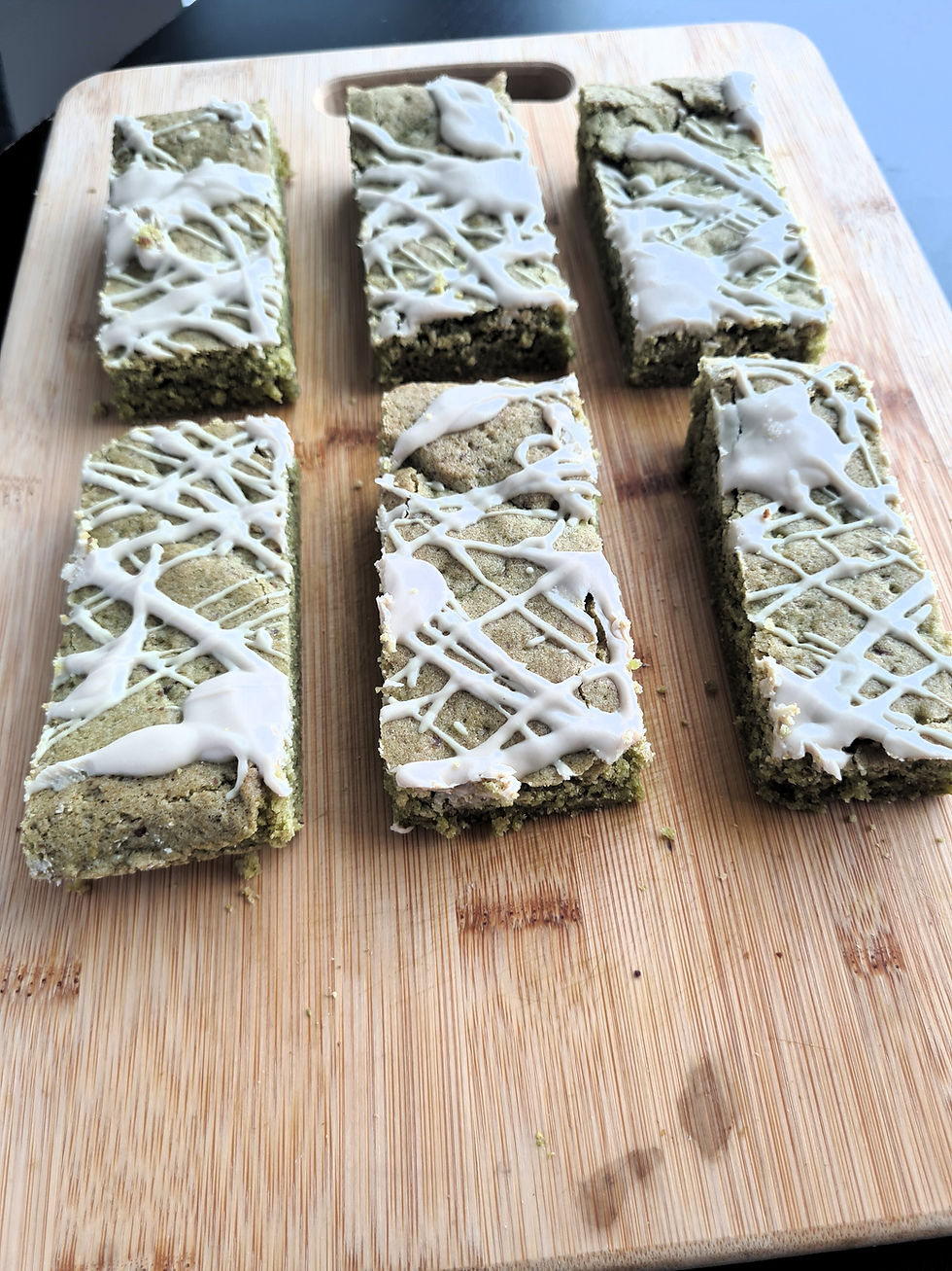 Overhead shot of several matcha blondies arranged neatly on parchment paper.