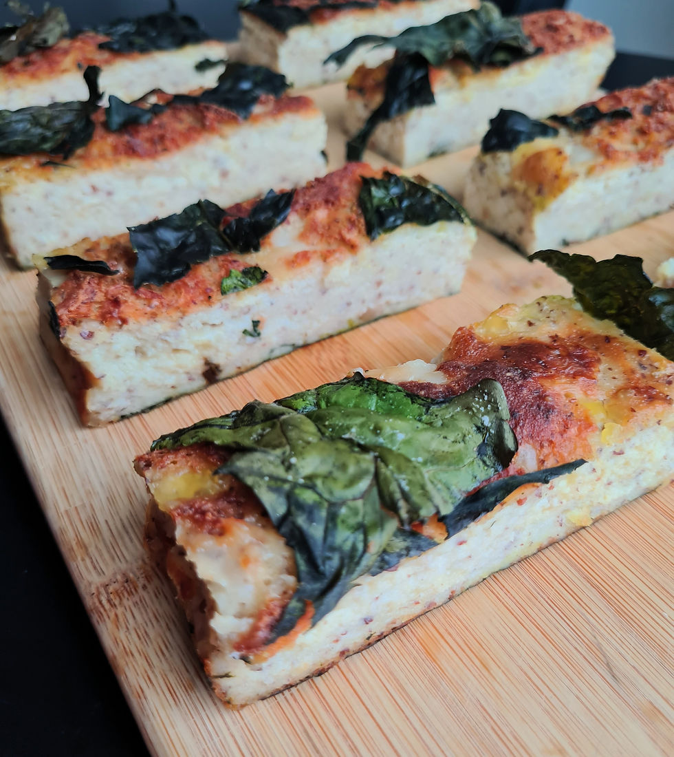 Slice of gluten-free vegan loznik with layers of yoghurt, cheese and spinach, baked golden brown