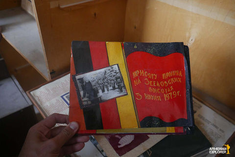 “Soviet-Armenian soldier’s album cover with photo and handwritten inscription.”

“Title page of Soviet soldier’s album, Ereván–Vapuiki, 1981–1983.”

“Hand-painted illustration of girls and cartoon character Wolf from ‘Ну, погоди!’ in soldier’s album.”

“Painting of a train entering a military boot, tearing it apart, from soldier’s album.”

“Photo of Soviet Minister of Defence Dmitri Ustinov with handwritten note in soldier’s album.”